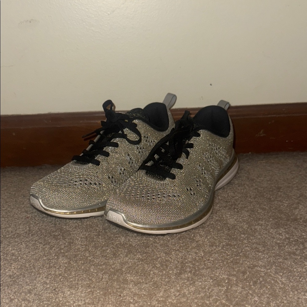 NEVER WORN APL Women’s Black and Gold Athletic Shoes
